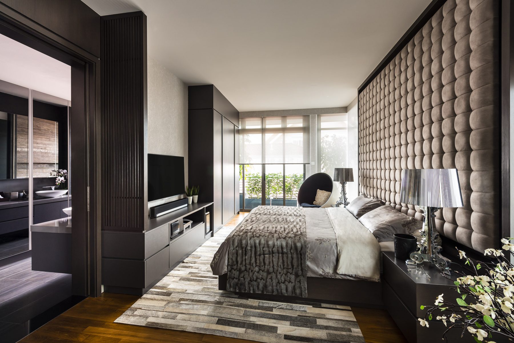 Bedroom with a floor-to-ceiling padded wall, dark timber joinery and a patchwork rug, Berwick Drive (2014)