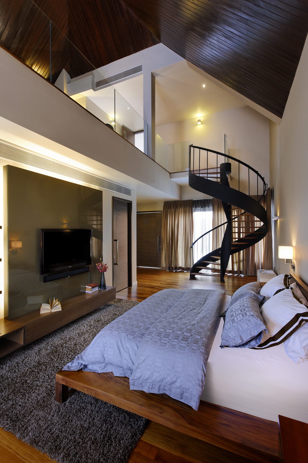 Double-height bedroom with a timber ceiling, glass-balustraded mezzanine and a black spiral staircase, Branksome Road (2010)